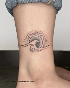 a woman's foot with a small wave tattoo on the side of her leg