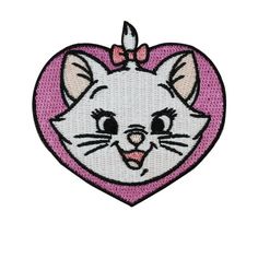 a white cat with a pink bow on its head in a heart shaped frame embroidered onto the back of a t - shirt