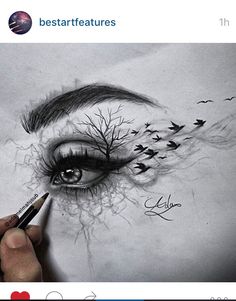 someone drawing an eye with pencils on paper