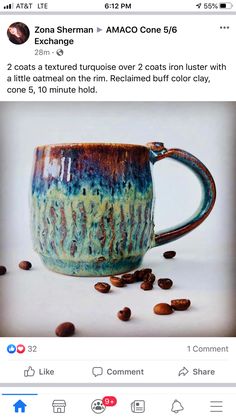 a coffee mug sitting on top of a table next to some coffee beans and cinnamons