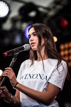 a woman standing in front of a microphone