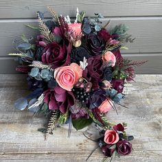 a bouquet of flowers sitting on top of a wooden table