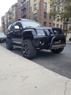 a black suv is parked on the side of the road