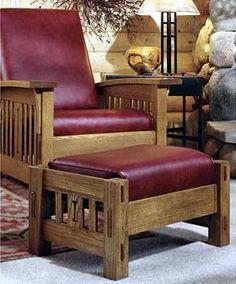 a wooden chair with red leather seat and foot rest in front of a stone fireplace