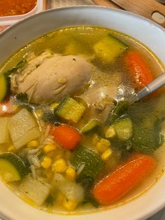 a white bowl filled with soup and vegetables