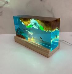 a wooden box with an image of people swimming in the water on top of it