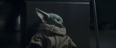 the child yoda from star wars is looking at something