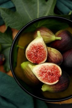 figs in a bowl with leaves around them