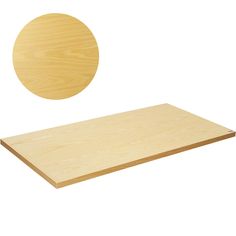 a wooden table top with a circular object in the middle and one piece of plywood behind it