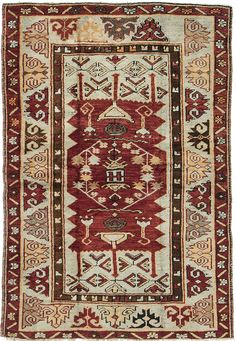 an old rug with red and beige colors on the bottom, surrounded by other decorative items