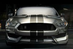 the front end of a silver and black mustang