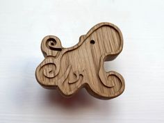 a wooden brooch with an elephant on it