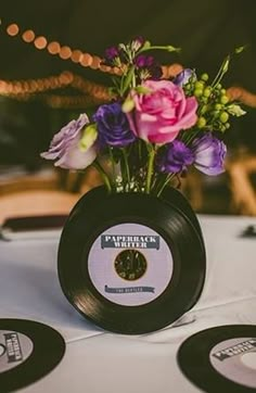 there is a vase with flowers in it on top of the table at this wedding reception