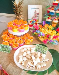 there are many cupcakes and oranges on the table