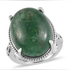 a large green stone surrounded by silver accents