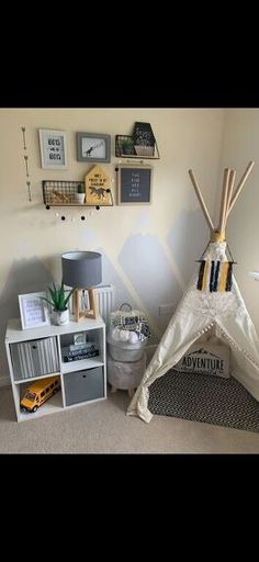 a child's bedroom with a teepee tent and other items on the wall