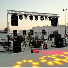 an outdoor stage set up with lights and sound equipment