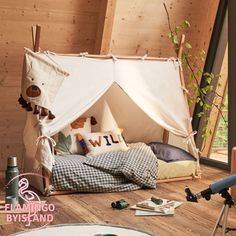 a bedroom with a teepee tent on the floor