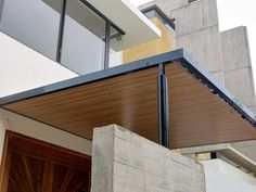 a modern house with wooden slats on the roof