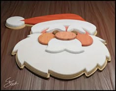 an image of a santa claus face on the floor with woodgrain and paint