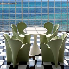 a table and chairs in front of an ocean view