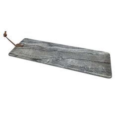 a gray marble board with a metal hook attached to it's end, on a white background