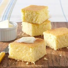 three pieces of cake sitting on top of a wooden cutting board