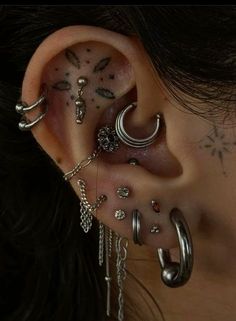 a woman with many piercings on her ear