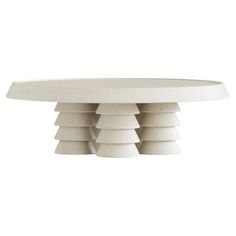 a white table with six stacks on it's top and four smaller ones in the middle