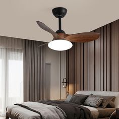 a bedroom with a bed, ceiling fan and window in the corner next to it