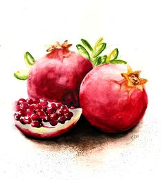 two pomegranates on a white surface