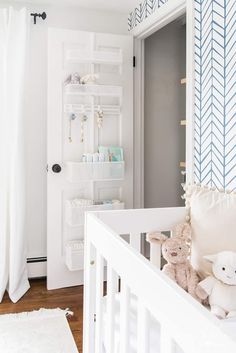 a baby's room is decorated in white and blue