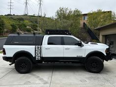 a white truck parked in front of a house