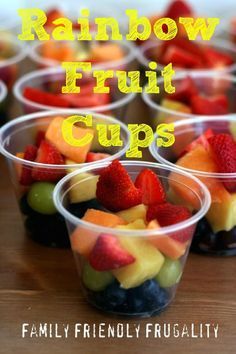 small plastic cups filled with fruit on top of a wooden table