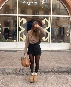 Cute fall outfits ideas for girls. Casual comfy fall outfits inspo. Fall fashion inspo for women. Brown oversized sweater, black mini skirt and tights, white crew socks and comfy shoes outfit inspiration for fall. Fall fits inspo for girls. #fallfashion #falloutfits #cutefalloutfits #comfyfalloutfits #casualfalloutfit Fall Mini Skirts, Brown Skirt Black Tights, Ugg Inspired Outfits, Fall Outfits Skirt And Sweater, Uggs Skirt Outfit, Skirt With Uggs Outfit, Skirt And Uggs Outfits, Brown Skirt Winter Outfit, Ugg Skirt Outfit