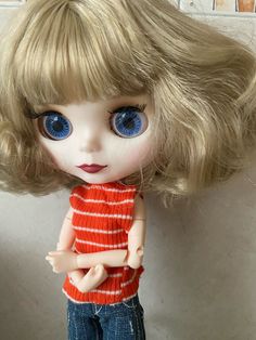 a doll with blonde hair and blue eyes