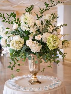 a vase filled with white flowers on top of a table