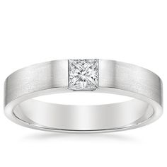 a white gold ring with a princess cut diamond