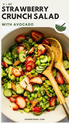 strawberries and cucumber salad with avocado in a white bowl