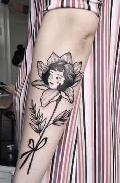 a woman with a flower tattoo on her arm