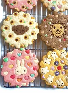 several decorated cookies sitting on top of a cooling rack