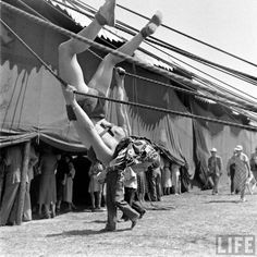 an old black and white photo of people doing acrobatic tricks