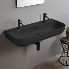 a bathroom sink sitting under a mirror next to a stool and table with a potted plant on it