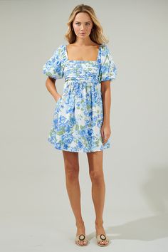 The Truth Be Told Blue Floral Pleated Midi Dress is a brunch-worthy find! It features a pleated design in the front with a square neckline and short puff sleeves. It has pockets on each side a smocked back for easier access. You will love this mini dress as much as we do! - Square neck- Bubble sleeves- Pocket- Smocked- Color: Blue CreamSize + Fit - Model is 5'8" and wearing size XS- Measurements taken from size S - Chest: 16"- Length: 27 1/2" Fabric Self: 100% Cotton Lining:97% Polyester 3% Span Short Dresses Floral, Floral Homecoming Dresses, Cute Formal Dresses, Truth Be Told, Blue Dress Formal, Cute Prom Dresses, White Short Dress, Pleated Mini Dress, Church Dresses