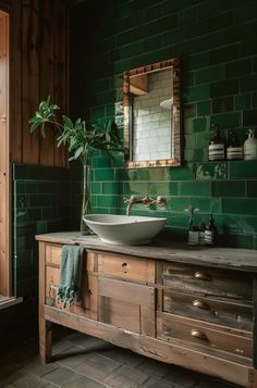 a bathroom with green tiled walls and wooden cabinets, a large mirror above the sink