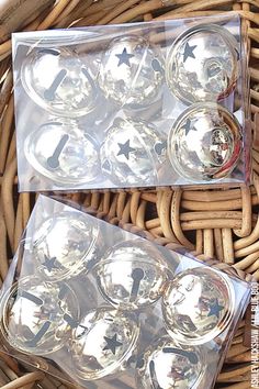 a basket filled with lots of shiny glass balls in it's packaging next to each other