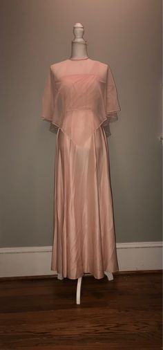 "- Gorgeous 70's pale pink dress with sheer overlay/cape - Comes with rope belt that allows for the cape to be fitted to body (if needed) - As pictured, cape can be removed. Dress has 3 straps at one shoulder.  - size 7/8 - see measurements below - Dress is polyester - by Creations of Aria Measurements: Chest: 32\" Waist: 24\" Hips: free Length: 50\" Cape: free PLEASE NOTE: - all items are pre-owned and may have normal wear and wash - vintage sizes are different and may vary / I'll try my best t Pink Cape Dress For Wedding, Pink Cape Evening Dress, Dress With Sheer Overlay, Vintage Striped Shirt, Pale Pink Dress, Bridesmaid Dresses Boho, Seventies Fashion, Rope Belt, Peach Dress