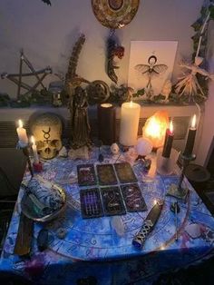 a table topped with lots of different types of candles and cards on top of it