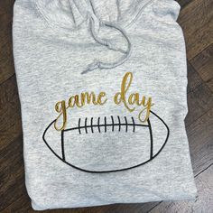 Gear up for game day in style with our Football Game Day Hooded Sweatshirt. Crafted with passion and designed for comfort, this premium sweatshirt combines athletic flair with everyday wearability. Emblazoned on the chest is a bold "Game Day" alongside a meticulously embroidered football, celebrating your love for the sport. The plush interior ensures warmth and coziness, making it perfect for chilly stadium nights or casual hangouts with fellow fans. Game Day Football, Beach Gear, True Red, Football Game, Football Games, Game Day, Pocket Pouch, Hooded Sweatshirt