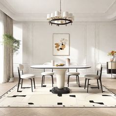 an elegant dining room with white walls and wood flooring